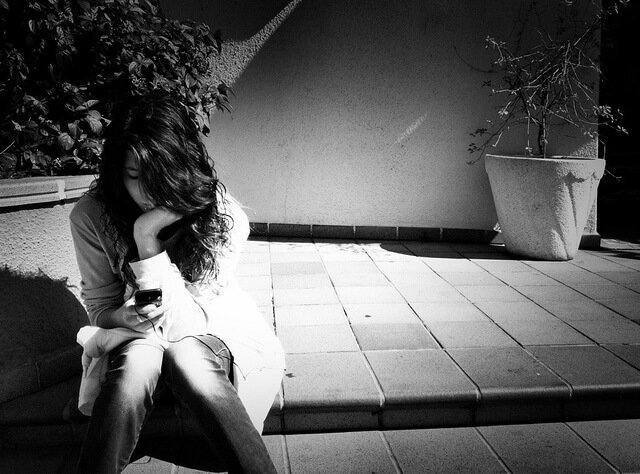 Bored Girl sitting in Shadows